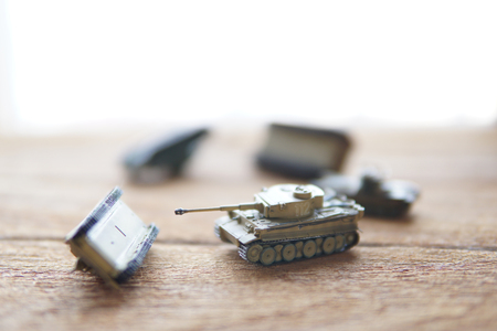 old toy tanks on wooden background.The battle.の写真素材