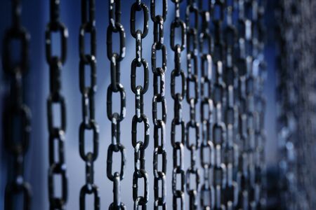 Perspective of metal chains curtain background. Selected focus.