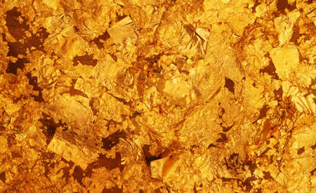 The dark gold leaf foil texture background.の写真素材