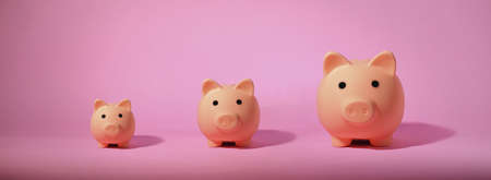Piggy bank isolated on pink background. Saving money concept.