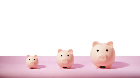 Piggy bank isolated on pink background. Saving money concept.の写真素材