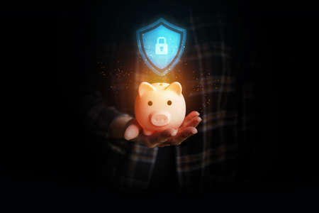 Piggy bank on woman's hand. Security money concept.