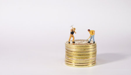 Worker figure standing on bitcoin. Bitcoin mining concept.の写真素材