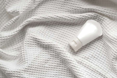 lotion tube mockup isolated on white fabric background.の写真素材