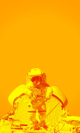 Space suits isolated on yellow background. Elements of this image furnishedの写真素材