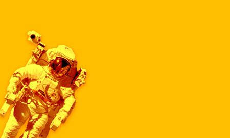 Space suits isolated on yellow background. Elements of this image furnishedの写真素材