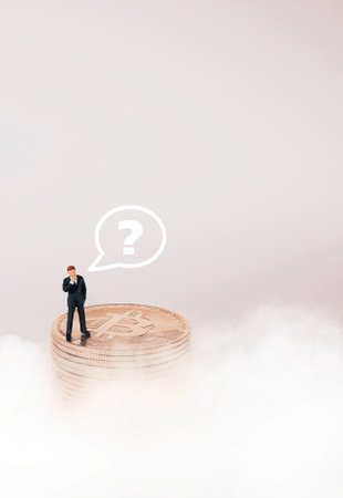 Business man figure standing on bitcoin and cloud background. Bitcoin mining concept.の写真素材