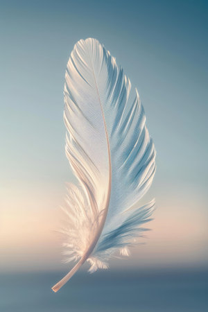A white feather floating in the air against a blue background..の素材