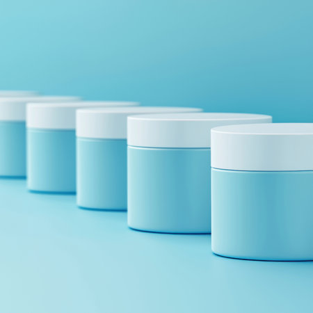 Line of blue cosmetic jars on a minimalist background for beauty and skincare.の素材