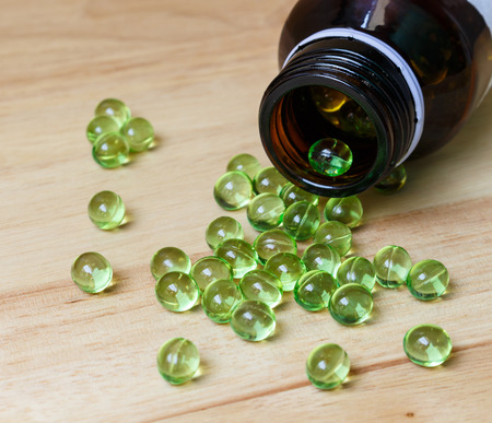Supplement foodVitamin E capsule on wooden table.の写真素材