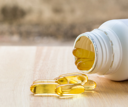 Evening primrose oil capsule on wood,supplementary foodの写真素材