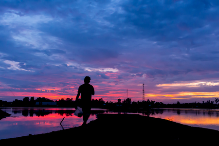 silhouette photo,shadow of man is walking on twilight time.の写真素材