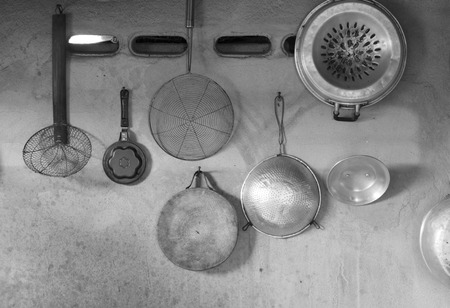 kitchenware hang on cement wall,mono tone.の写真素材