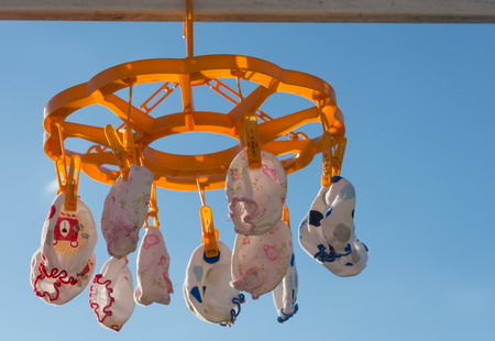 baby Gloves and socks on railの写真素材