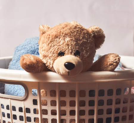 Teddy Bear in Basket with Towelの写真素材