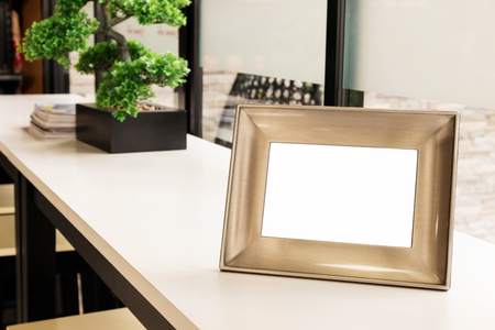 Picture frame placed on a table in a coffee shopの写真素材