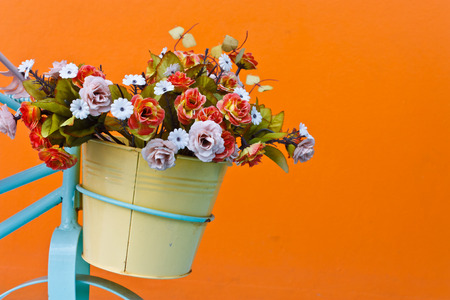 decorative the bicycle with artificial flowers on color wall backgroundの写真素材