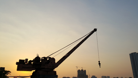 Tower crane on a construction site at sunset