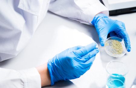 Close-up of scientists researching pathogens to make vaccines, biotechnology studies from bacterial cells in a lab, researchers culture in petri dishes.の写真素材