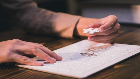 Close-up of business hands connecting jigsaw puzzle, business problem solving, success and goal achievement, the last jigsaw is the link of all the pieces.の写真素材