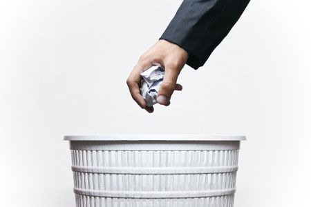 A man throwing waste in a bin isolated with white background.