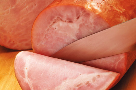 Sliced ham on a cutting board, close-up.の写真素材