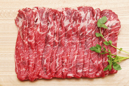 Raw fresh beef sirloin with parsley on wooden cutting boardの写真素材