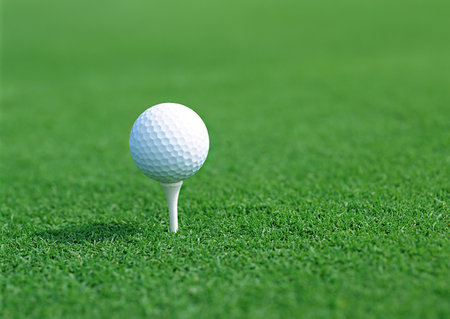 Golf ball on green grass ready to be shot into the holeの写真素材