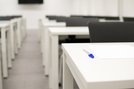 Classroom empty. High school or university desk or table with a pen on top. Exam test roomの写真素材