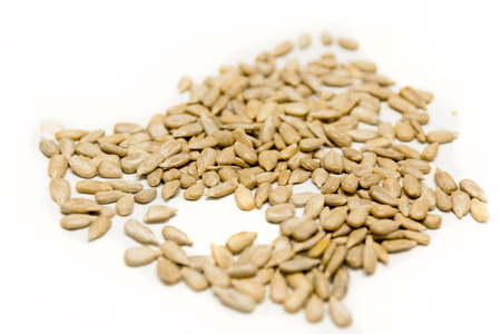 Pile of sunflower seeds isolated on white background. Vegan food