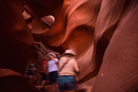 Tourists in motion blur. Tour at Antelope canyon, Arizona. Adventure travel tour concept.の写真素材