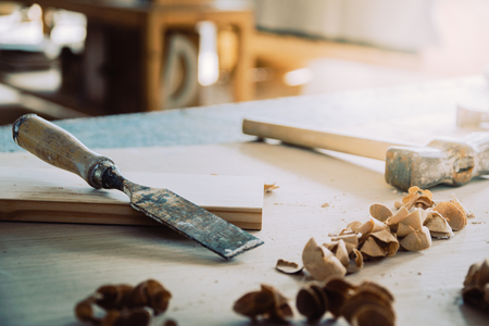 Chisel or gouge for wood on carpenter workbench. Carpentry workshop. Carpenter tools. Sawdust. DIY...