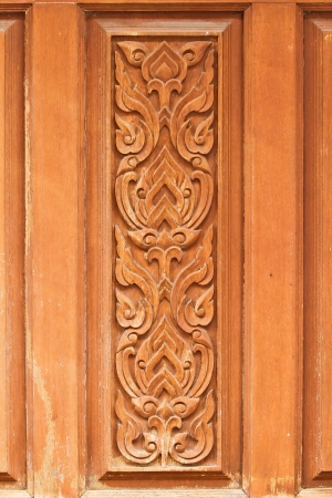 thai delicate pattern carved on temple wooden door の写真素材