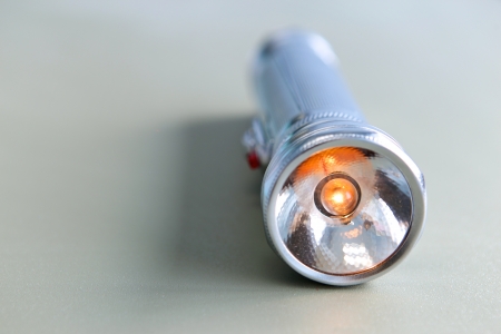 conventional metal totch with its light bulb turned onの写真素材