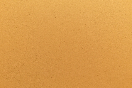 background of vividly orange plain concrete wallの写真素材