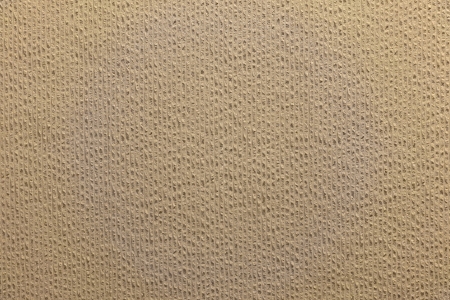 background of groove surfaced light brown concrete wallの写真素材