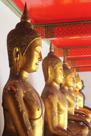 golden buddha images in sitting version with meditation pose, wat pho, thailandの写真素材