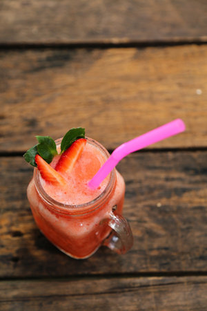 Strawberry Smoothie in jar top view on wooden table for summer time have blank space.の写真素材