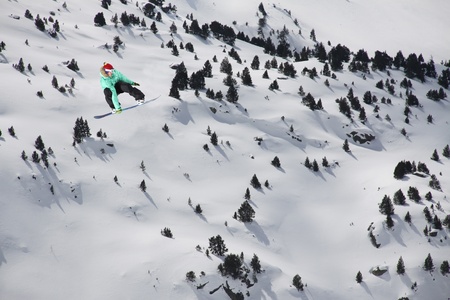 flying snowboarder on mountains の写真素材