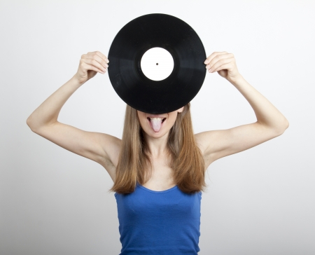 Girl with vinyl disc, isolated on whiteの写真素材