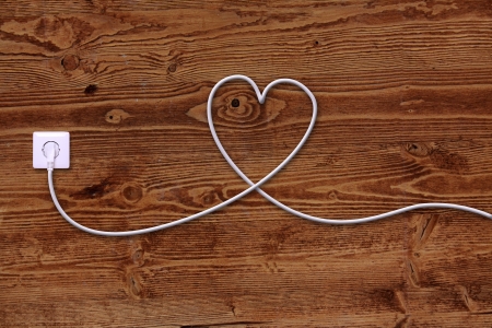 electrical outlet and wire in the shape of a heartの写真素材