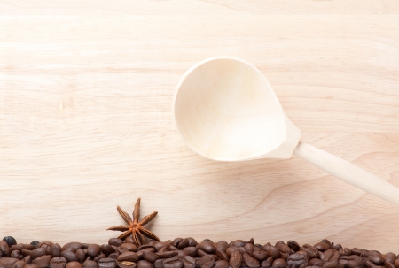 coffee beans on wooden table with wooden spoonの写真素材