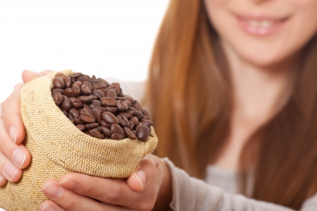 woman holding a small bag of coffee beansの写真素材