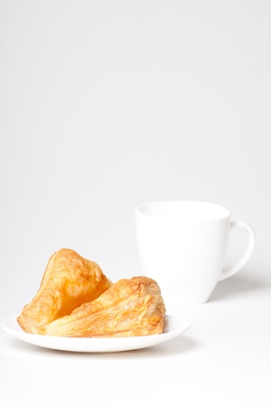 Breakfast with coffee and croissants on white backgroundの写真素材