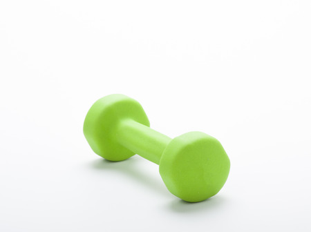 small green dumbbell,  isolated in white backgroundの写真素材
