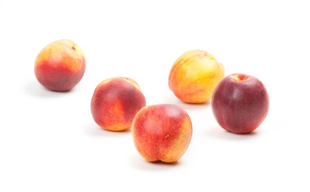 Ripe peaches fruits isolated on white backgroundの写真素材