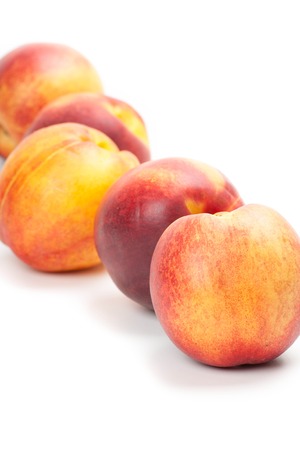 Ripe peaches fruits isolated on white backgroundの写真素材