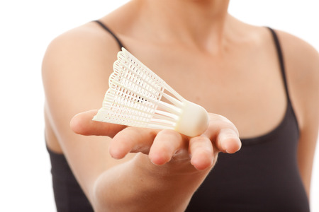 Hand holding shuttlecock, isolated on whiteの写真素材