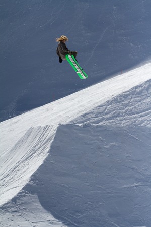 SOCHI, RUSSIA - MARCH 22, 2014: Snowboarder jumps in Snow Park,  mountain ski resort Rosa Khutor.のeditorial素材