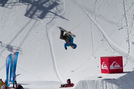 SOCHI, RUSSIA - MARCH 22, 2014: Snowboarder jumps in Snow Park,  mountain ski resort Rosa Khutor.のeditorial素材